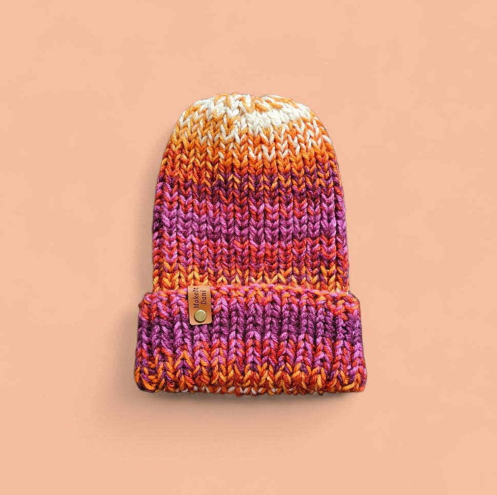 Knitted beanie with gradient colors on a beige background